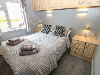 A bedroom with a bed and bedside table at 16 Badgers Retreat in Richmond