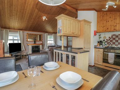 A kitchen with dining area at The Cedars in South Lakeland Leisure Village