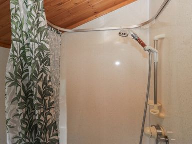 A shower with a curtain and controls at The Cedars South Lakeland Leisure Village