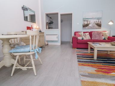 A living room with a dining table and chairs at Beachcomber in Marazion