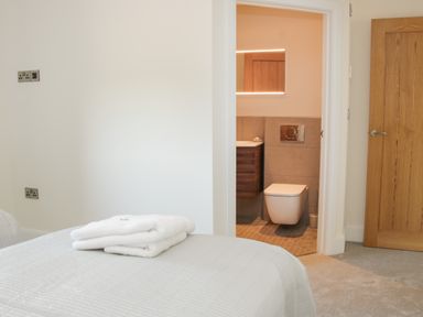 A bedroom with towels on the bed and a door open to a bathroom at Shepherd's Rest in Montgomery