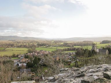 A rural village with houses fields and a church tower surrounded by trees and hills at Shepherd's Rest in Montgomery