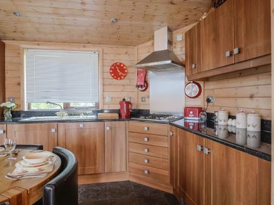 A kitchen with wood cabinets and countertop at The Cabin at East Hill Pride Four Elms Hill Nr. Sidmouth