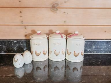 Kitchen canisters for sugar, coffee, and tea with ceramic eggs at The Cabin at East Hill Pride Four Elms Hill Nr. Sidmouth