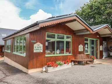 A cafe building with outdoor seating and signage at The Cabin at East Hill Pride Four Elms Hill Nr. Sidmouth