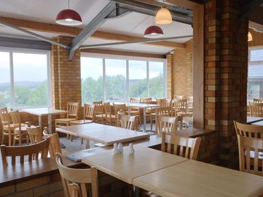 A dining room with tables and chairs at The Cabin at East Hill Pride Four Elms Hill Nr. Sidmouth