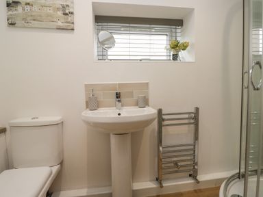 A bathroom with a sink and toilet at Coney Garth Cottage Beckermet