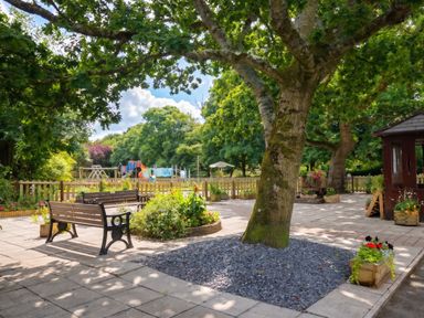 An outdoor area with benches and a playground at Coney Garth Cottage in Beckermet