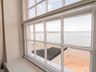 A view of boats on the water through a multi-pane window at Searles in Lympstone