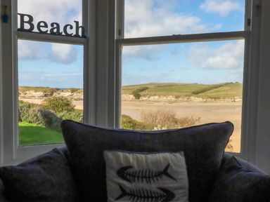 A living room with a view of the beach at Seashore House in Porth