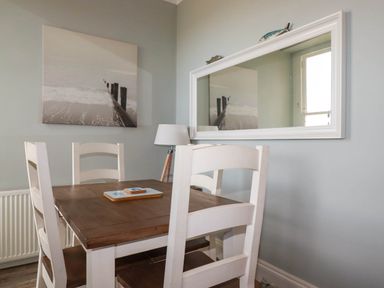 A dining room with a table and chairs at Seashore House in Porth