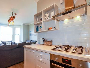 A kitchen with a stove and a countertop at Seashore House Porth