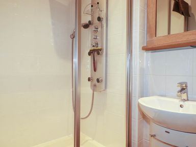 A bathroom with a shower and sink at Seashore House in Porth