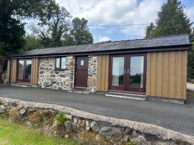 An exterior view of a building with stone and wood features at Bothi in Llanuwchllyn