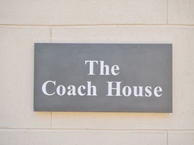 A sign showing The Coach House at Pendower House Fowey