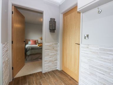 A bedroom entrance with doors and a lamp at Cegin Foch in Chwilog