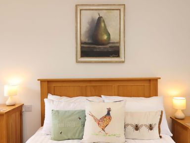 A bedroom with a bed and artwork at Cawsand in Tideford