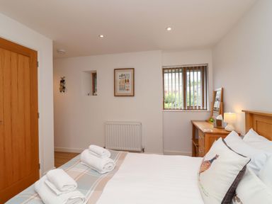 A bedroom with a bed and dresser at Cawsand in Tideford