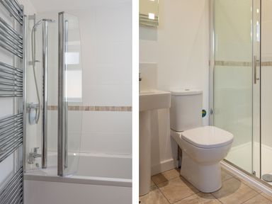 A bathroom with a bathtub shower combination and a separate shower enclosure with a toilet and sink at Godrevy in St Ives
