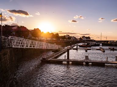 A marina with boats docked and a sunset in the background at Harbour View Cottage in Watchet