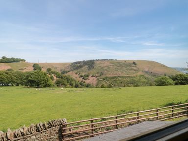A view of hills and fields at Penrhiwarwydd Barn in Pontywaun