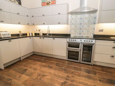 A kitchen with cabinets and appliances at The Turnip Barn