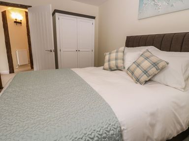 A bedroom with a bed and a wardrobe at The Turnip Barn in 