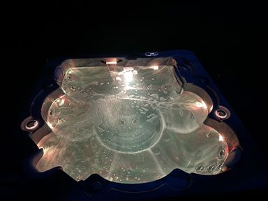 A hot tub with illuminated water at Willow Lodge Constantine near Falmouth