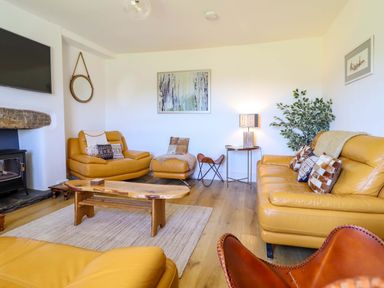 A living room with sofas and a coffee table at Cefn Nannau Ty-nant near Cerrigydrudion