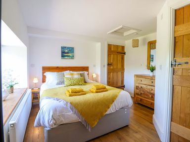 A bedroom with a bed and wooden furniture at Cefn Nannau near Ty-nant Cerrigydrudion