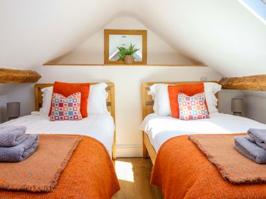 A bedroom with two beds and a mirror shelf at Cefn Nannau Ty-nant near Cerrigydrudion