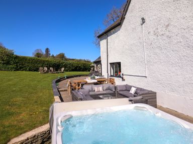 A garden area with a hot tub and outdoor seating at Cefn Nannau Ty-nant near Cerrigydrudion
