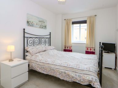 A bedroom with a bed and nightstand at Welymora in Pwllheli