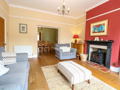 A living room with a sofa and fireplace at Tilly's Retreat in Hunstanton