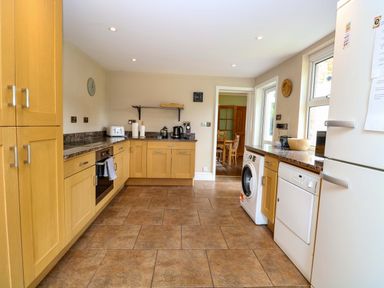 A kitchen with oak cabinets and appliances at Tilly's Retreat in Hunstanton