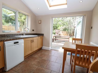 A kitchen with sink and table at Tilly's Retreat in Hunstanton