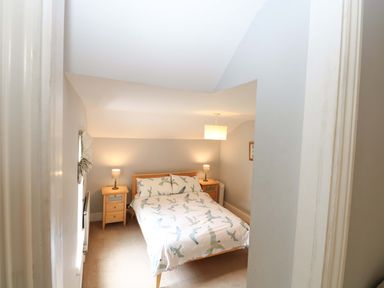 A bedroom with a bed and bedside tables at Tilly's Retreat in Hunstanton