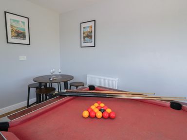 A game room featuring a pool table and a small table at Glanyrafon Bungalow St Harmon