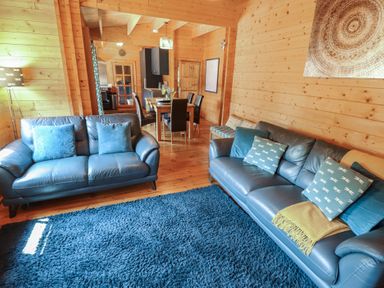 A living room with sofas and a dining area at Tythe Lodge – Hot Tub Retreat in Rural Lincolnshire | Family-Friendly Lodge Near Heckington