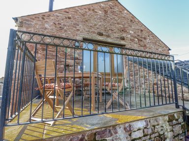 A terrace with a table and chairs at Apple Tree Cottage Bleatarn near Kirkby Stephen