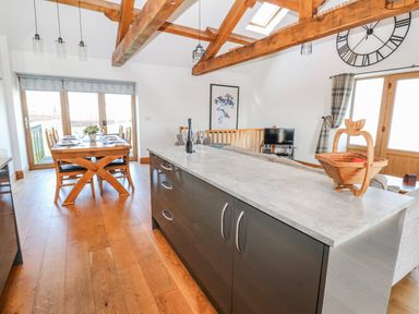 A dining room with a table and chairs at Apple Tree Cottage near Kirkby Stephen