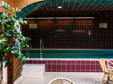 A pool area with stairs and plants at Bracken Lodge Wooler