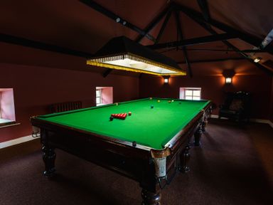 A games room with a pool table and lighting at Bracken Lodge in Wooler