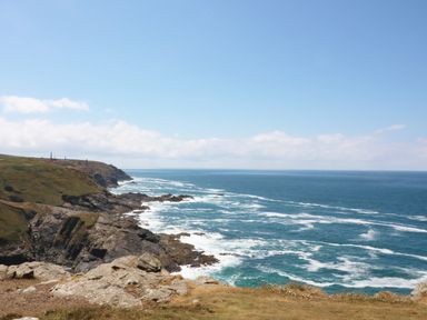 A coastline with rocky cliffs and the ocean under a blue sky at The Quillet in Pendeen