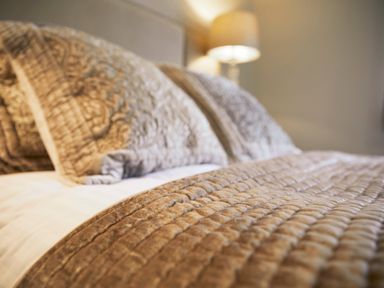 A close up of a bed with textured pillows and a quilted blanket at Holly Edge in Moorsholm