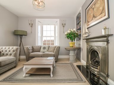 A sitting room with two sofas coffee table fireplace and a window at Penlaurel in Launceston
