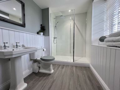 A bathroom with a sink toilet shower and window with blinds at Penlaurel in Launceston