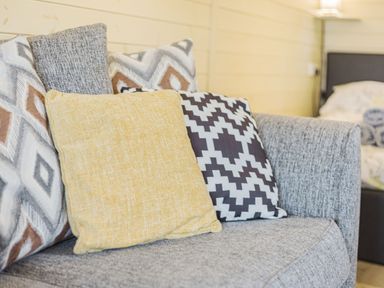 A grey sofa with multiple patterned cushions in a living space at Stiperstones Pod White Grit near Chirbury