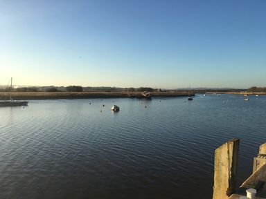A river with small boats and buoys on the water at Upham View in Woodbury
