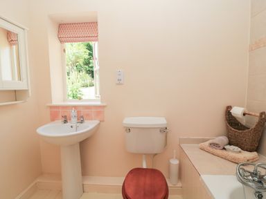 A bathroom with a sink and toilet at Upper Mill Barn, Coln St Aldwyns, near Bibury